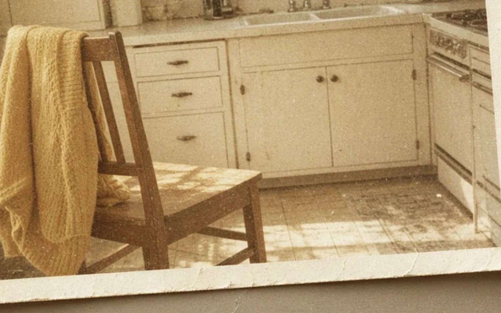 Close crop of a faded kitchen snapshot lying on a table with age damage, the problem this guide is measuring.