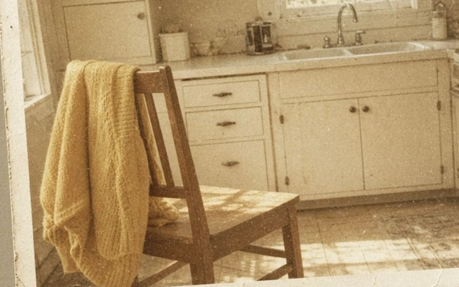 Close crop of a faded kitchen snapshot lying on a table with age damage, the problem this guide is measuring.