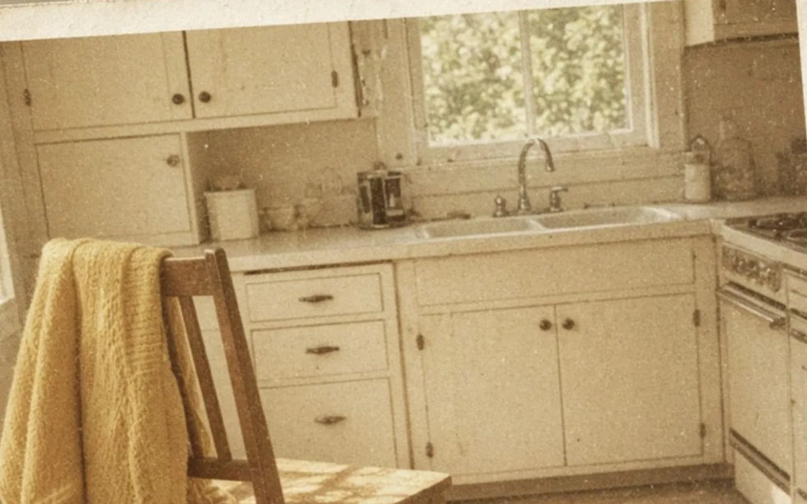 Close crop of a faded kitchen snapshot lying on a table with age damage, the problem this guide is measuring.