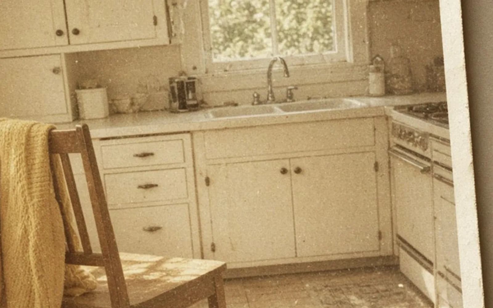 Close crop of a faded kitchen snapshot lying on a table with age damage, the problem this guide is measuring.
