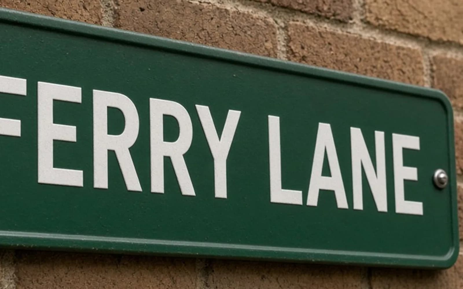 The same crop of a street sign reading FERRY LANE without the blur damage, kept for comparison.